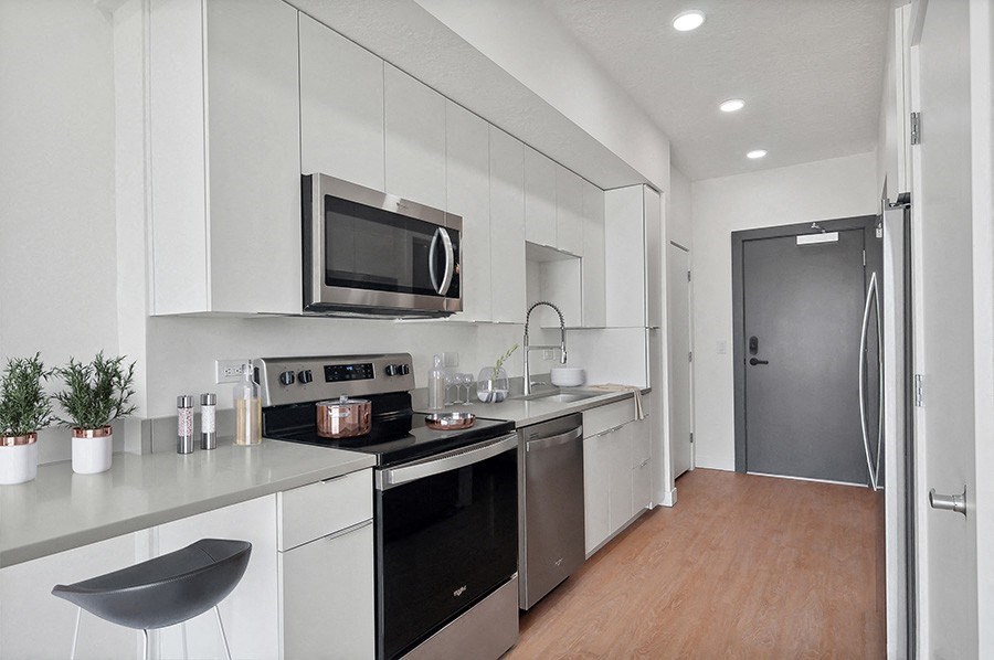 Model kitchen with modern cabinets and stainless steel appliances at 801 Flats located in Post District Residences in downtown Salt Lake City, Utah