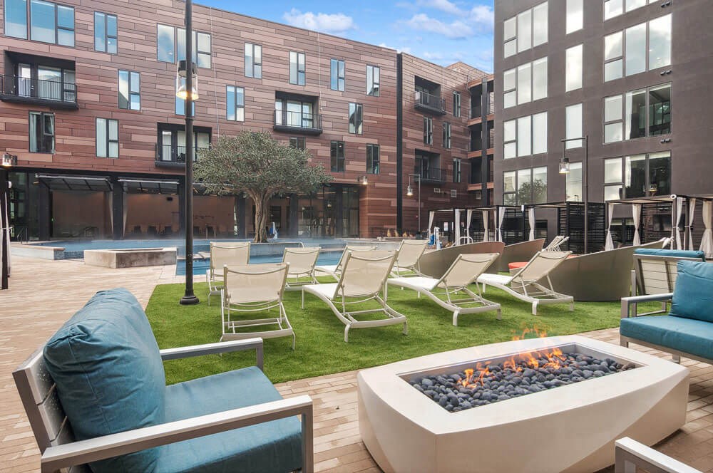 Expansive pool deck area with loungers and a firepit at Post District Residences in Downtown Salt Lake City, Utah