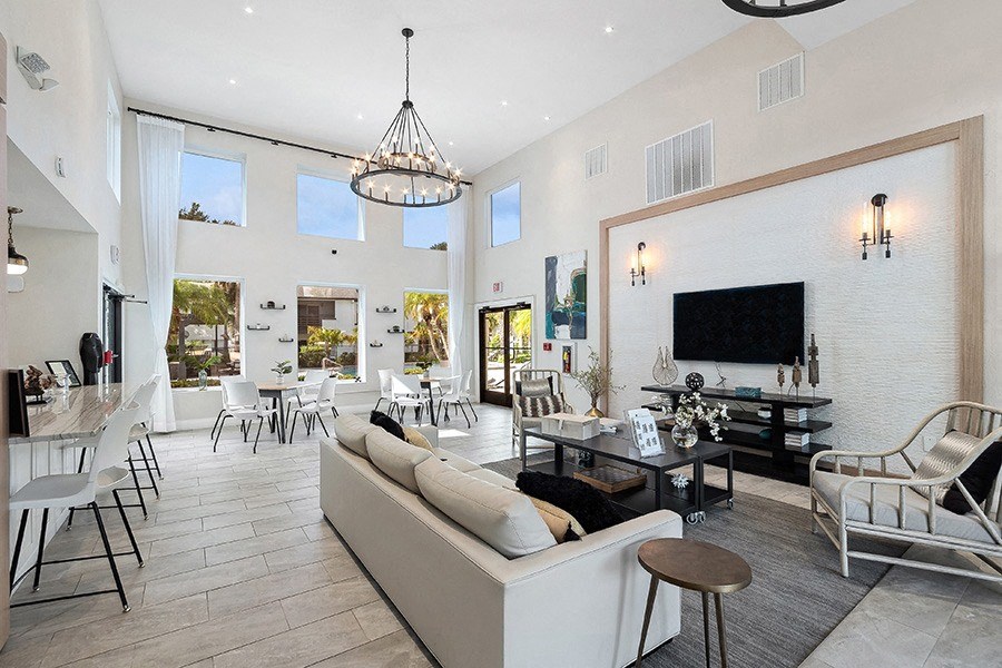 Community Clubhouse with Lounge Furniture and a TV at Rosehill Preserve Apartments in Orlando, FL.