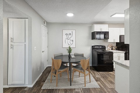 a kitchen and dining room with a table and chairs