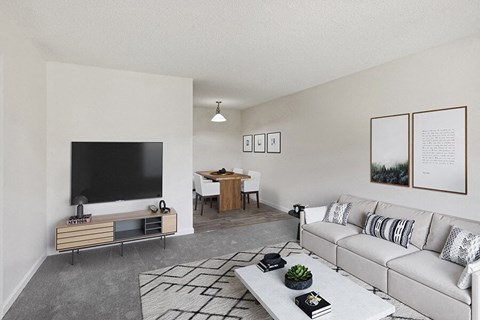 Model Living Room with Carpet and View of Dining Room at Walnut Creek Apartments located in Walnut Creek, CA.