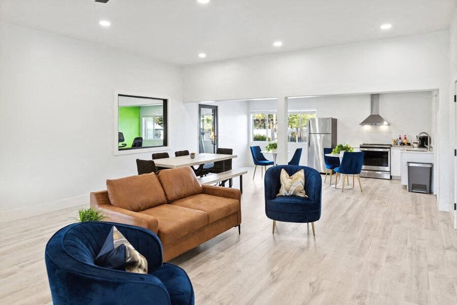 Resident clubhouse with a couch chairs and a table at Lakeside Casitas in Tucson, AZ