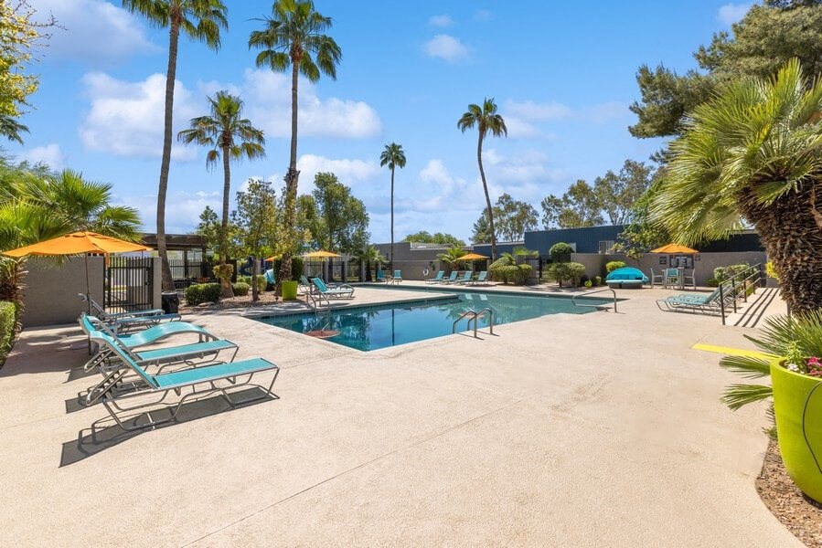 Community Swimming Pool with Pool Furniture at Lakeside Casitas Apartments in Tucson, AZ.