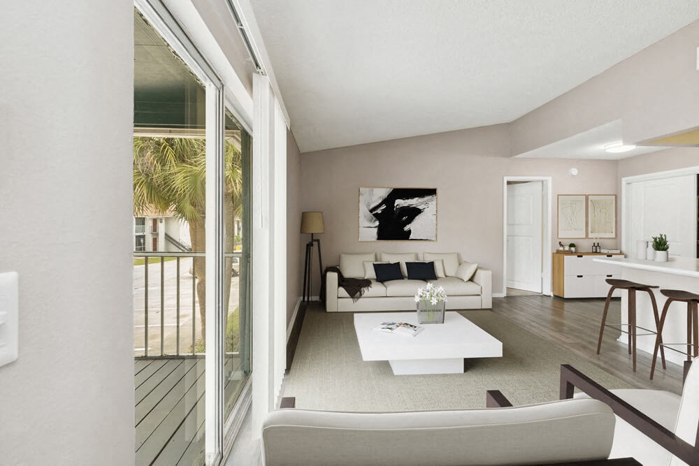 Model living room with white furniture and a white coffee table at Vue at Baymeadows Apartments in Jacksonville, Florida