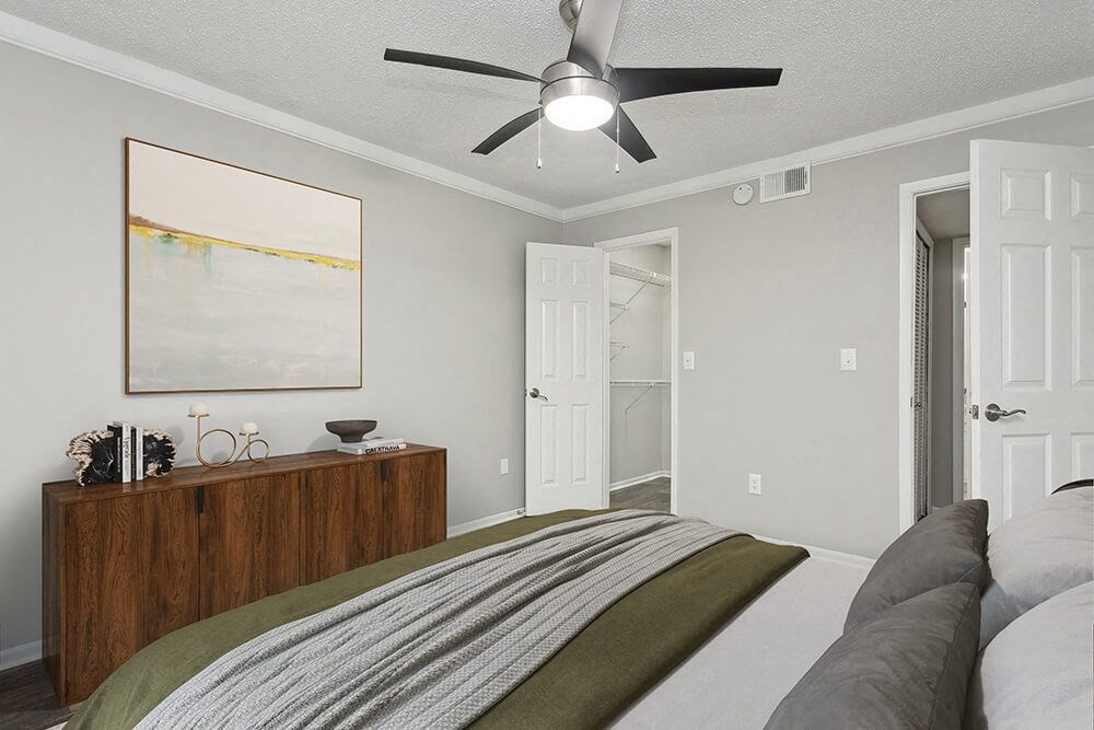 Model Bedroom with Carpet and attached Bathroom at Carrollwood Station Apartments in Tampa, FL.