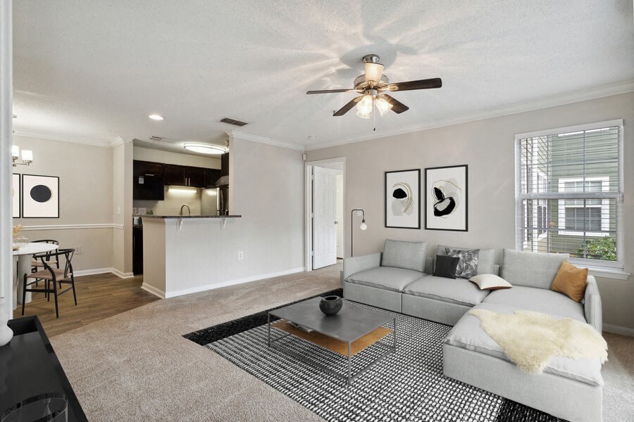 Model living room with view of kitchen