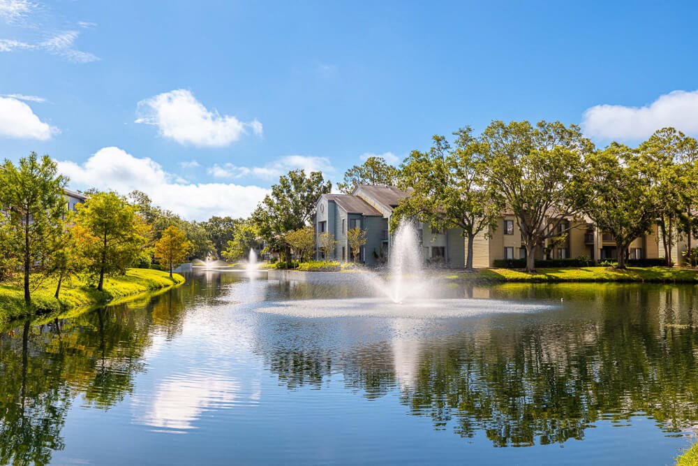 Private lake with fountain at Huntington Place Apartments in Sarasota, Florida
