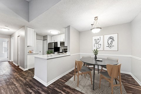 an open kitchen and dining room with a table and chairs