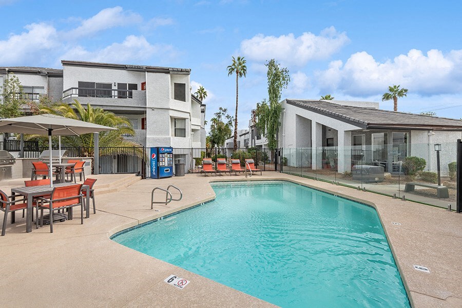 Community Swimming Pool with Pool Furniture at Crystal Creek Apartments in Phoenix, AZ.