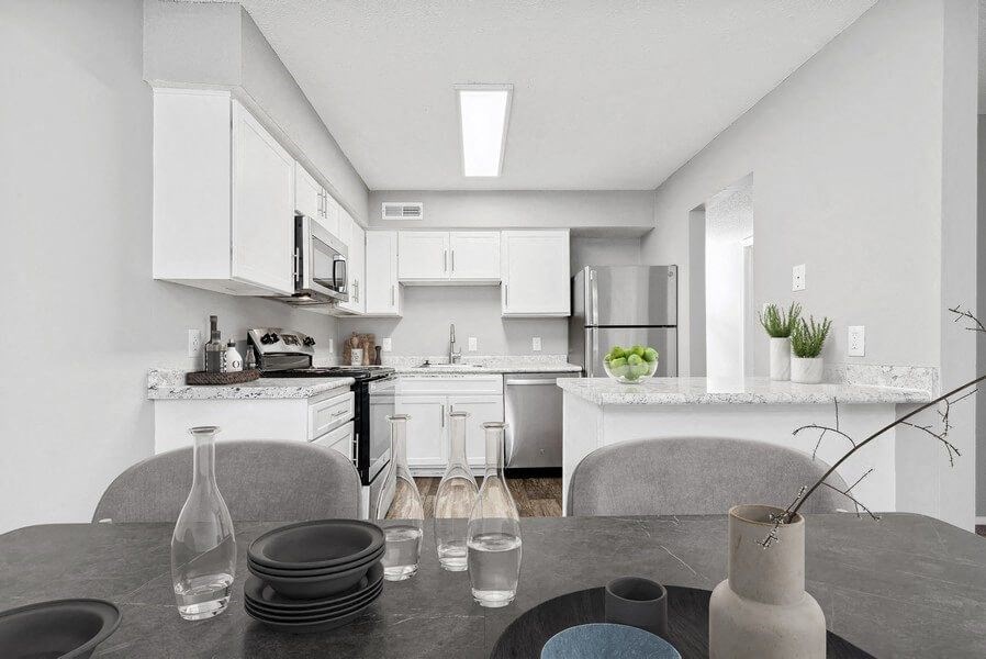 Model dining area with kitchen in background
