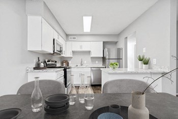 Model dining area with kitchen in background - Photo Gallery 5