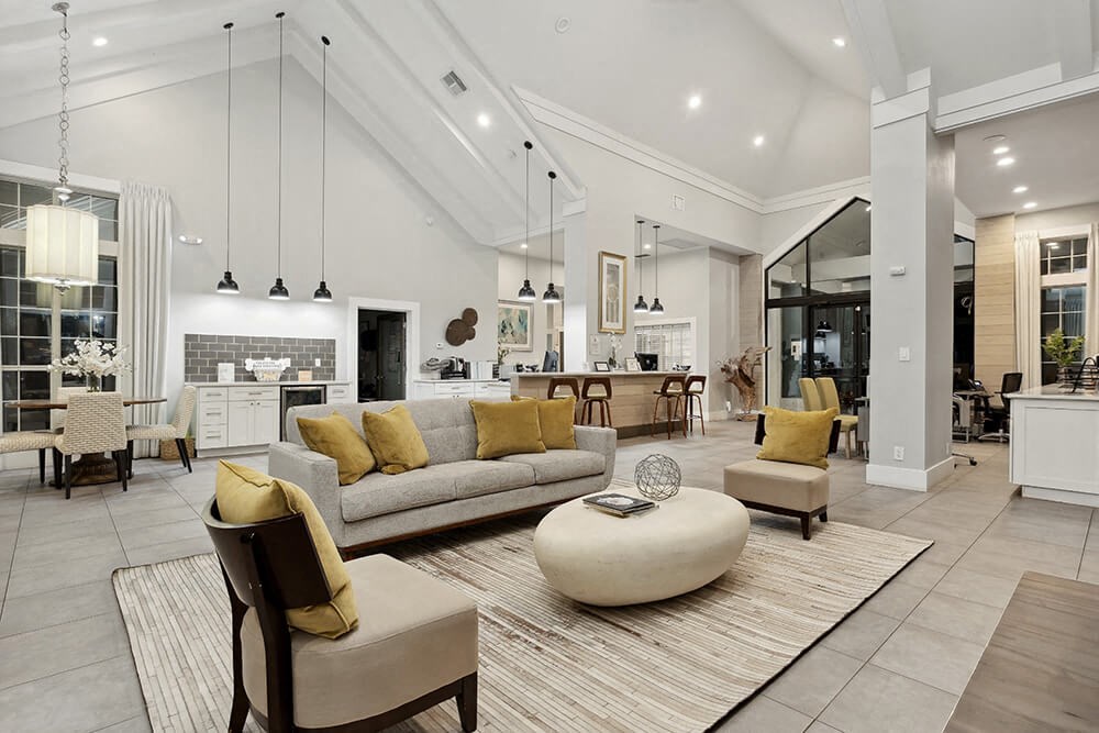 Community Clubhouse with Lounge Furniture and Kitchenette Area at Caribbean Breeze Apartments in Tampa, FL.