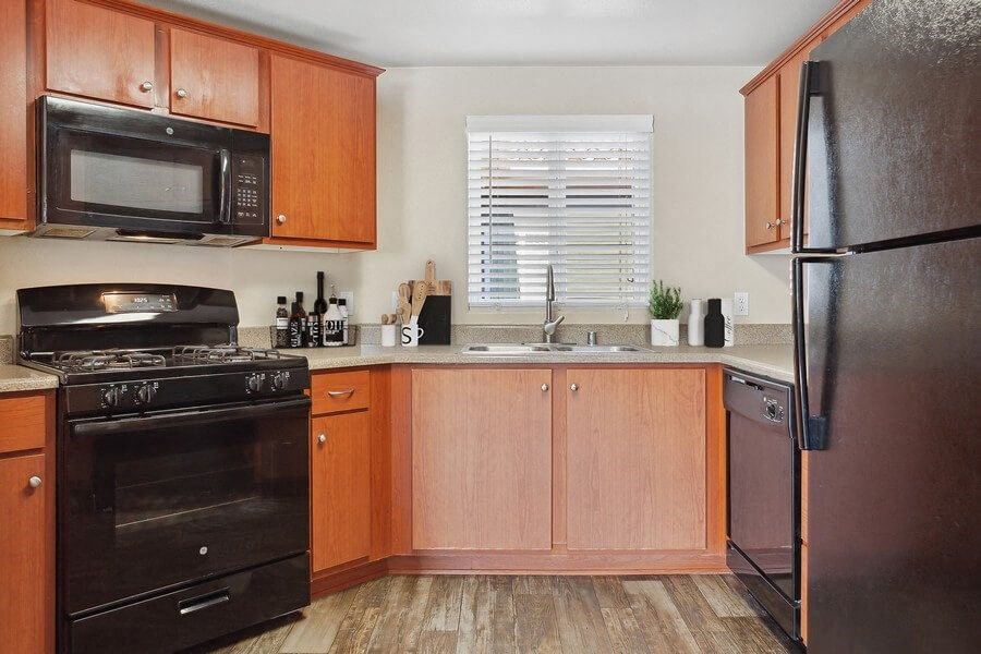Model kitchen with black appliances at Reserve at Rancho Apartments
