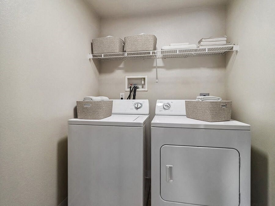Model Laundry Room with Washer & Dryer at Reserve at Rancho Apartments located in Moreno Valley, CA.