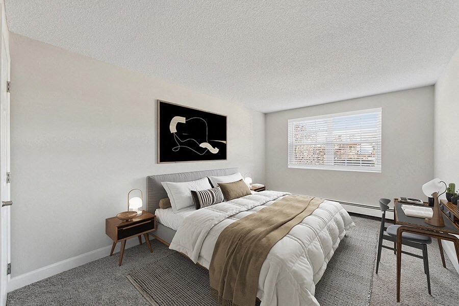 Model Bedroom with Carpet and Window View at Middlesex Crossing Apartments in Billerica, MA.