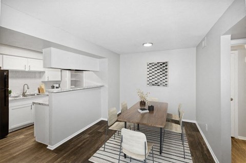a kitchen and dining room with a table and chairs