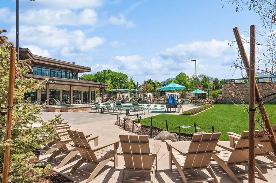 Outdoor Picnic Area with Lounge Furniture and View of Swimming Pool at Seven Skies Apartments located in Sandy, UT.
