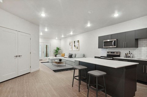 a kitchen and living room with a counter top