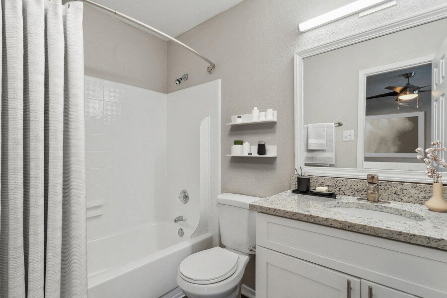 a bathroom with a shower and a sink and a toilet