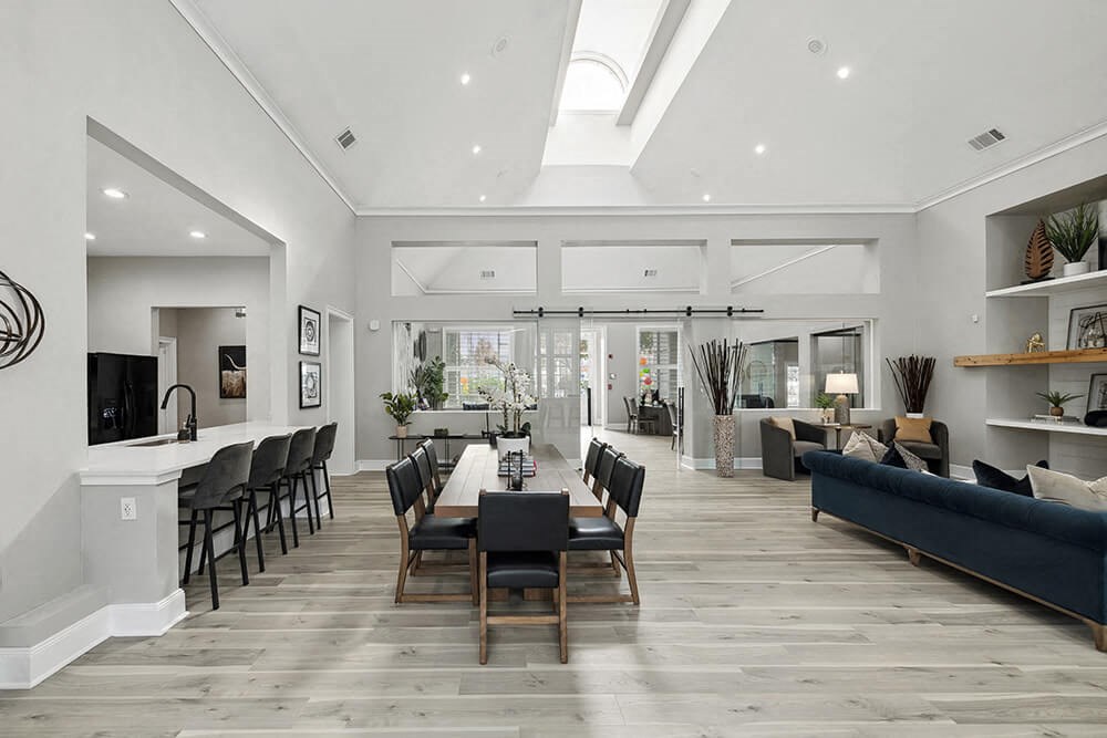 Community Clubhouse with Lounge Furniture and Kitchenette Area at Bridges at Oakbend Apartments in Lewisville, TX.