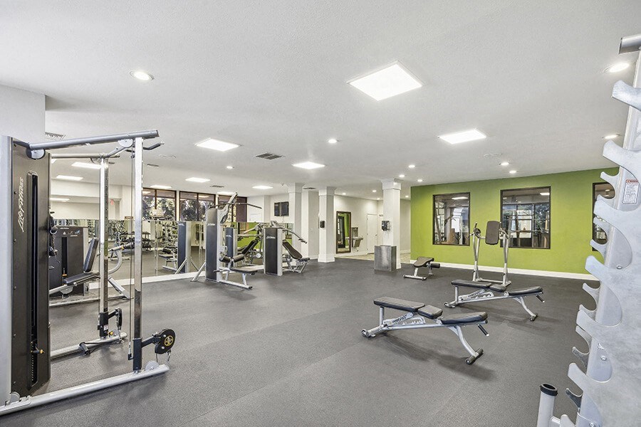 Community Fitness Center with Equipment at Madison Park Apartments located in Anaheim, CA.