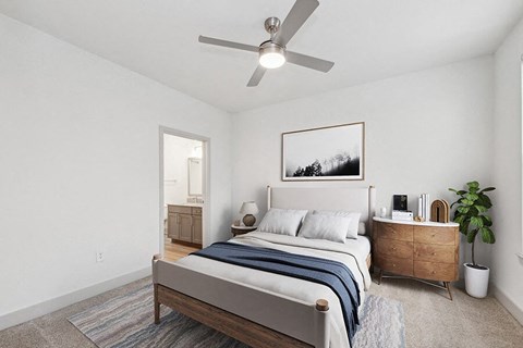 Model Bedroom with Carpet and attached Bathroom at Alta 3Eighty Apartments located in Aubrey, TX.