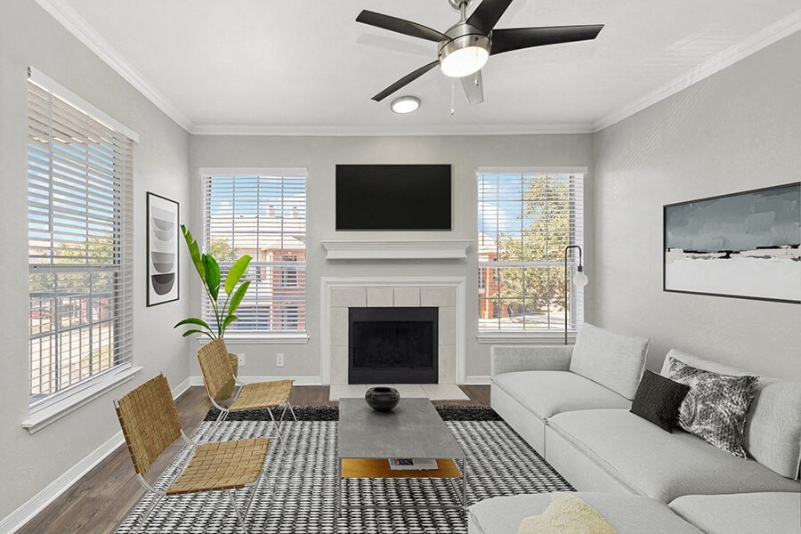 Model Living Room with Wood-Style Flooring and Fireplace at Chapel Hill Apartments in Lewisville, TX.
