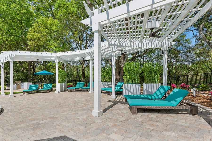 Community Patio with Pool Furniture at Grand Pavilion Apartments in Tampa, FL.