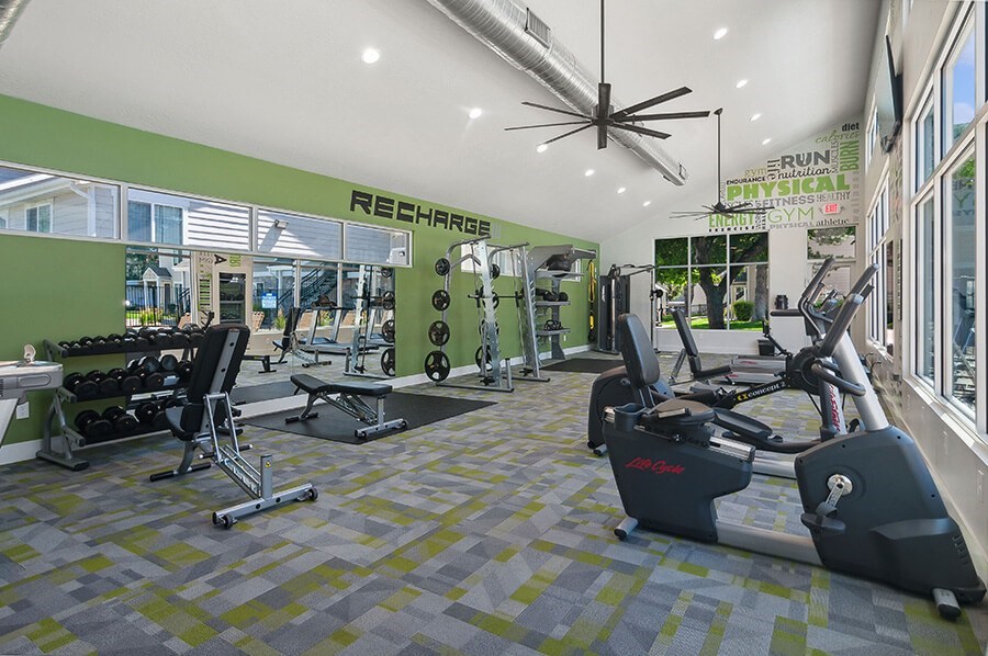 Community Fitness Center with Equipment at Broadmoor Village Apartments located in West Jordan, UT.