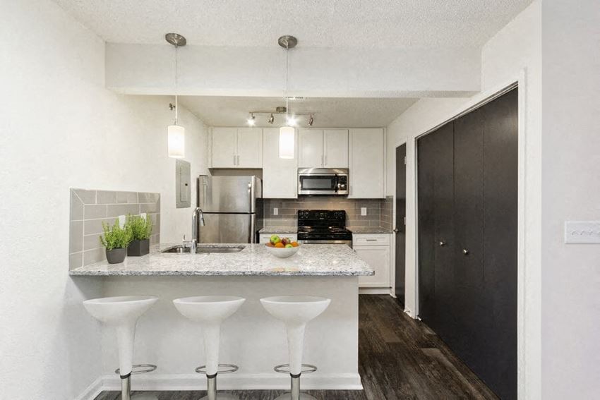 Model kitchen showcasing new appliances and bar seating