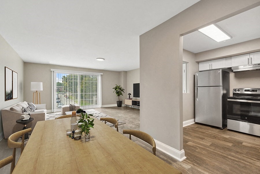 Model Dining Room with Wood-Style Flooring and View of Kitchen at Heights at Marlborough Apartments located in Marlborough, MA.