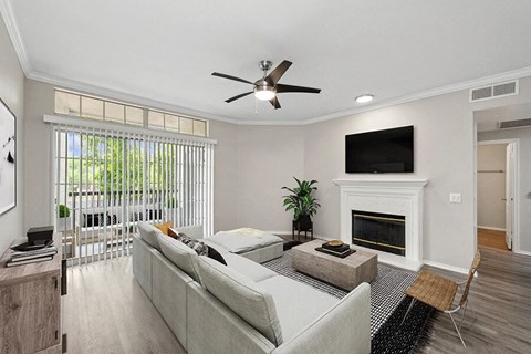 a living room with a couch and a ceiling fan