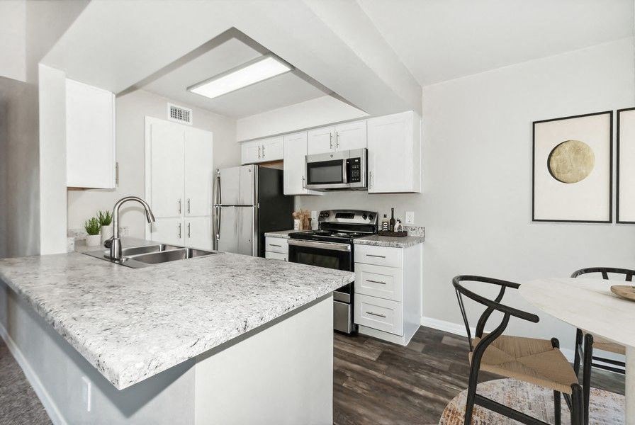 Model kitchen with white cabinetry