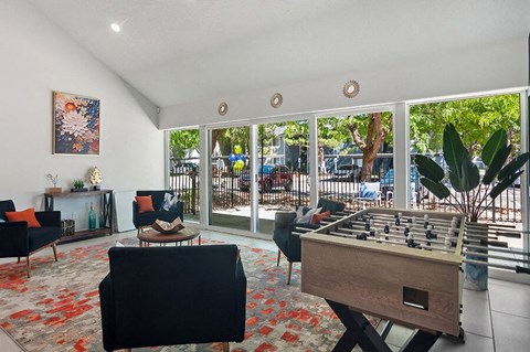 Community Clubhouse with Lounge Furniture and Game Tables at Overlook Apartments located in Salt Lake City, UT.