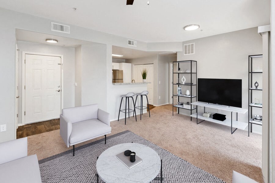 Model living room and bar seating kitchen