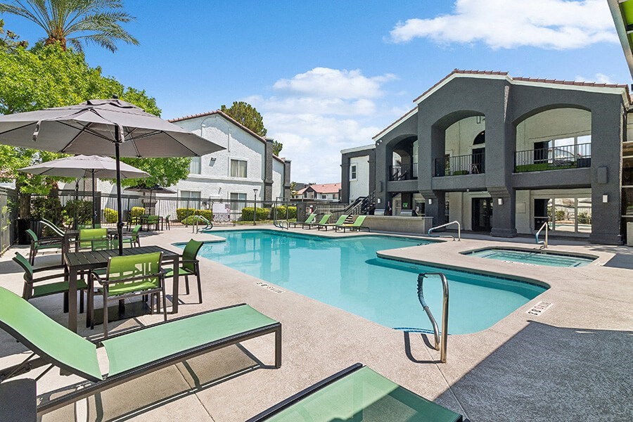 Community Swimming Pool with Pool Furniture at Meadow Ridge Apartments located in Las Vegas, NV.