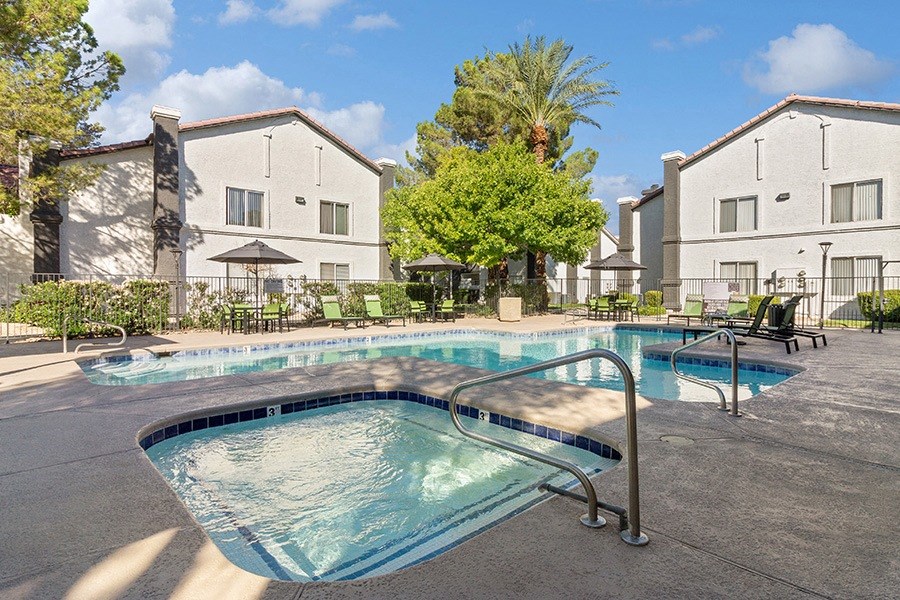 Community Swimming Pool with Pool Furniture at Meadow Ridge Apartments in Las Vegas, NV.