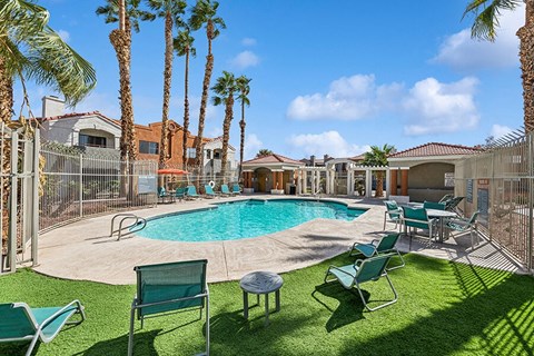 Community Swimming Pool with Pool Furniture at Stonegate Apartments located in Las Vegas, NV.