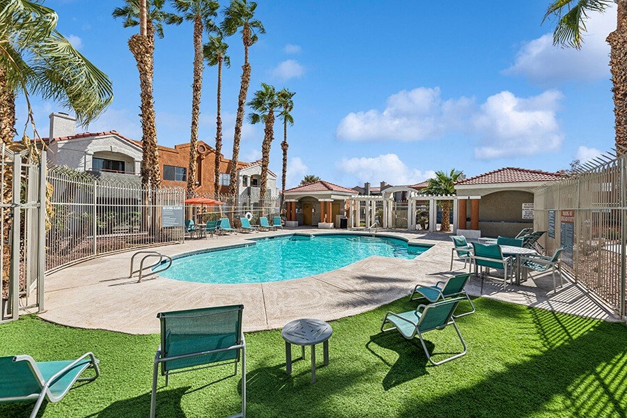 Community Swimming Pool with Pool Furniture at Stonegate Apartments located in Las Vegas, NV.