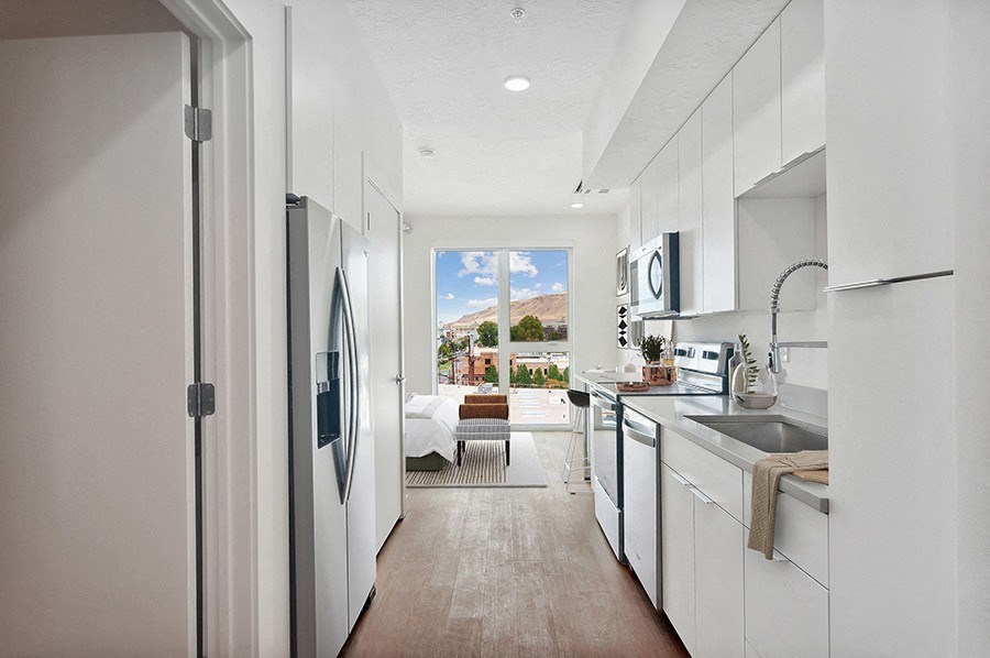 Model kitchen and entry with large windows at 801 Flats located in Post District Residences in downtown Salt Lake City, Utah