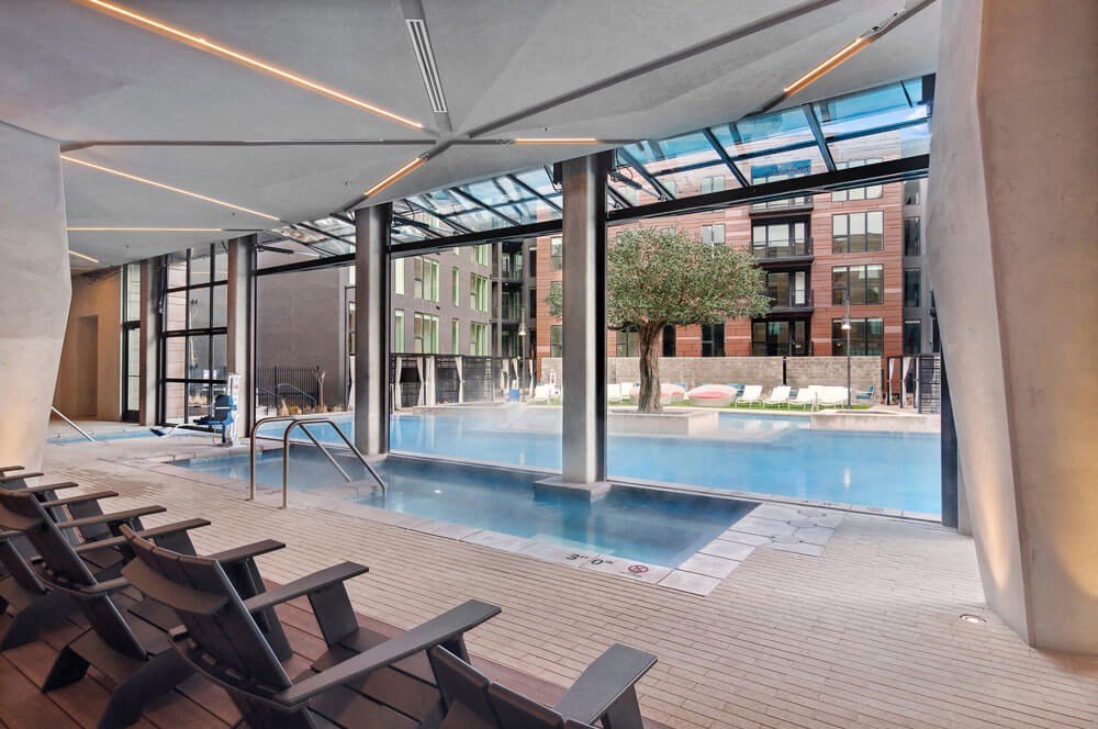 Convertible indoor/outdoor spa area with access to the swimming pool at Post District Residences in Downtown Salt Lake City, Utah