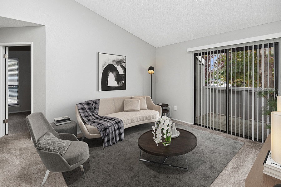 Model Living Room with Carpet and Patio Accessibility at The Meritage Apartments in Vallejo, CA.