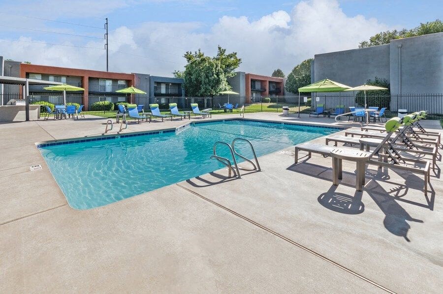 Community Swimming Pool with Pool Furniture at Indigo Park Apartments in Albuquerque, NM.
