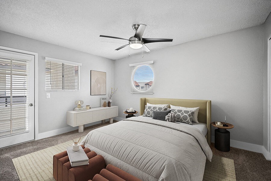 Model Bedroom with Carpet and Patio Accessibility at Stillwater Apartments located in Glendale, AZ.