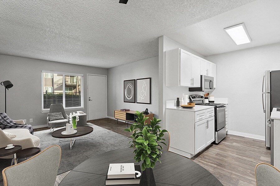 Model Dining Room and Kitchen Area with View of Living Room at The Archer Apartments in Sacramento, CA.
