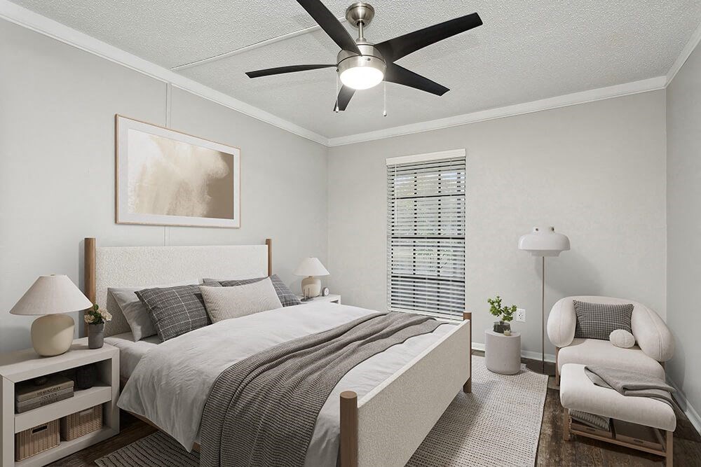 Model Bedroom with Carpet and Window View at Carrollwood Station Apartments in Tampa, FL.