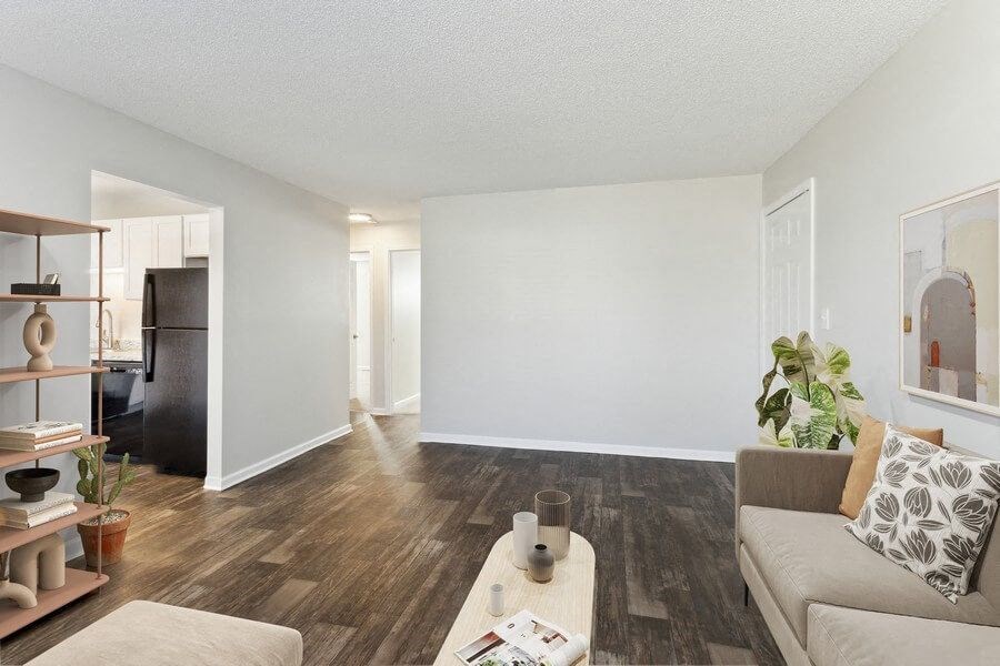 Model living room with view of kitchen