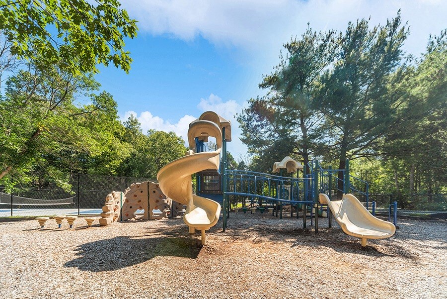 Community Playground with a Slide and Climb Wall at The Commons at Haynes Farm Apartments in Boston, MA.