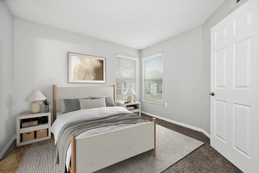 Model Bedroom with Carpet and Window View at Retreat at Crosstown Apartments in Riverview, FL.