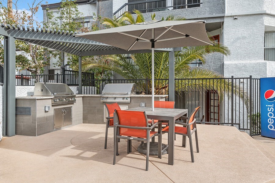 Outdoor BBQ Area with Furniture and Canopy at Crystal Creek Apartments in Phoenix, AZ.
